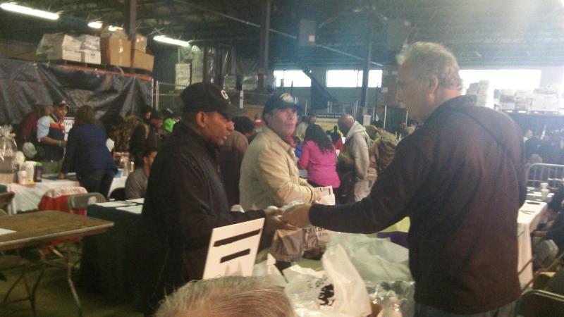 President AE La Piana hands a Homeless Person Survival Kit to a homeless veteran