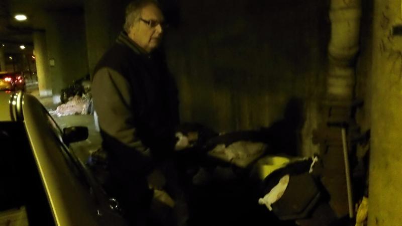 La Piana gives food to homeless man under lower wacker dr- Chicago